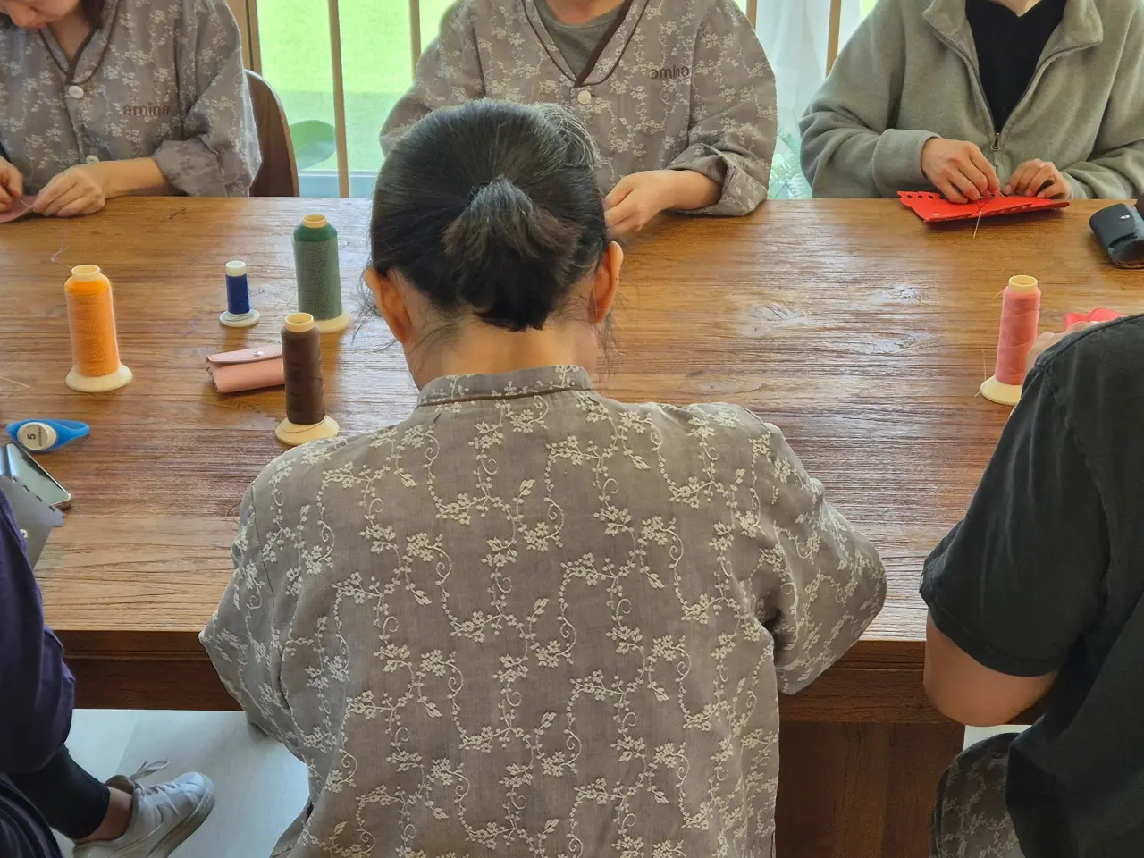 색색의 실타래가 놓인 가죽공예 테이블